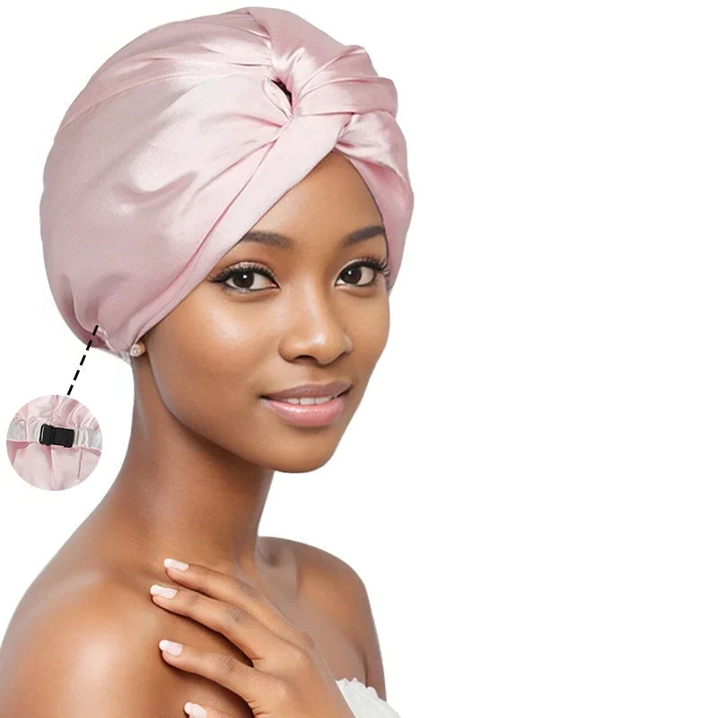 Woman wearing a pink satin head wrap with three other head wraps in black, red, and blue displayed above her.