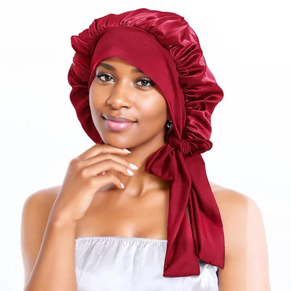 Red silk bonnet providing luxurious overnight hair protection