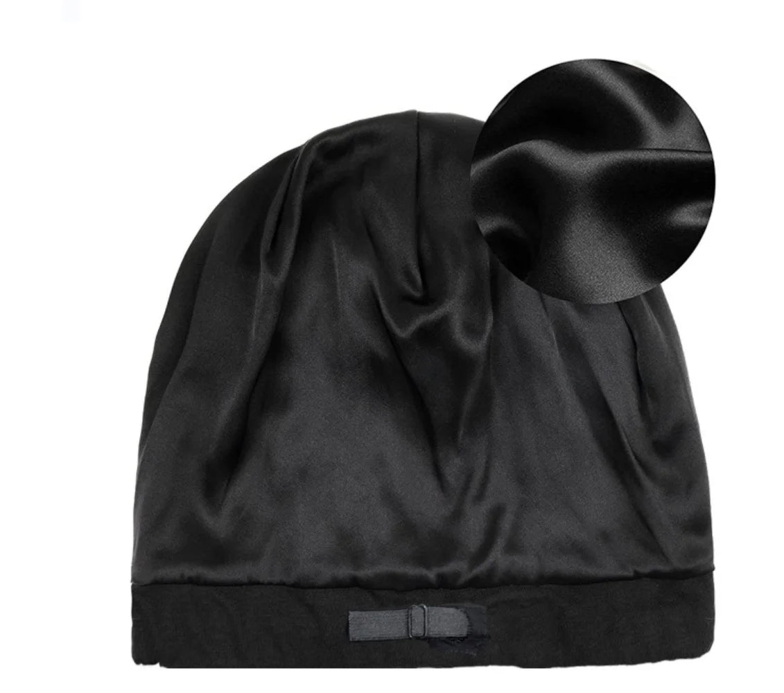 Close-up of black satin lined bamboo beanie showing smooth interior and elastic fit for hair protection.